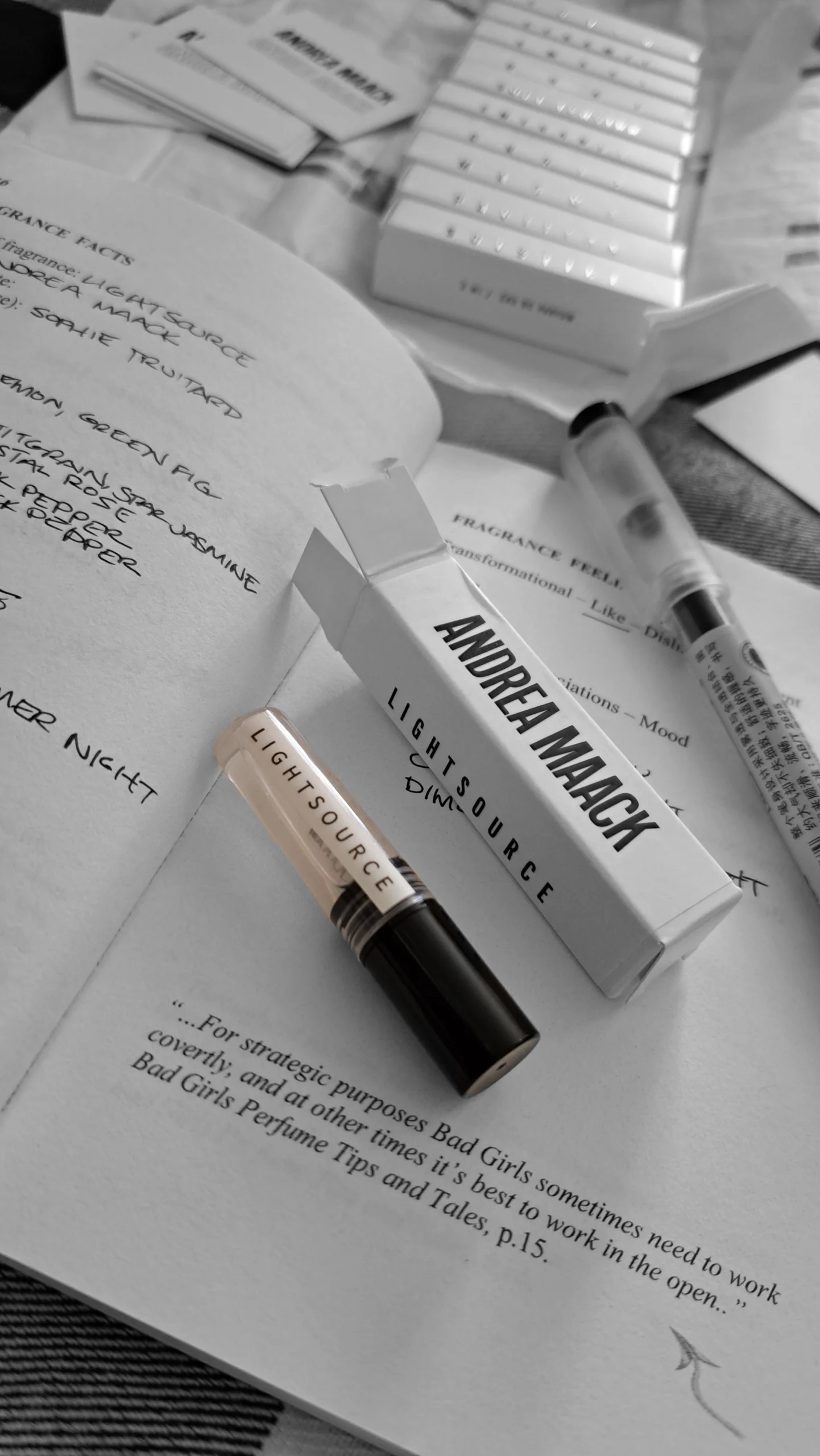 Andrea Maack Lightsource perfume sample with white packaging on an open notebook.