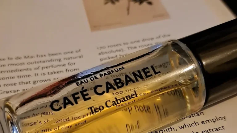 Teo Cabanel Café Cabanel perfume bottle with golden liquid and black cap on a plain background.