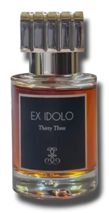 A clear product shot of the Ex Idolo Thirty-Three perfume bottle against a transparent background, showcasing its amber-colored liquid and distinctive grooved cap.
