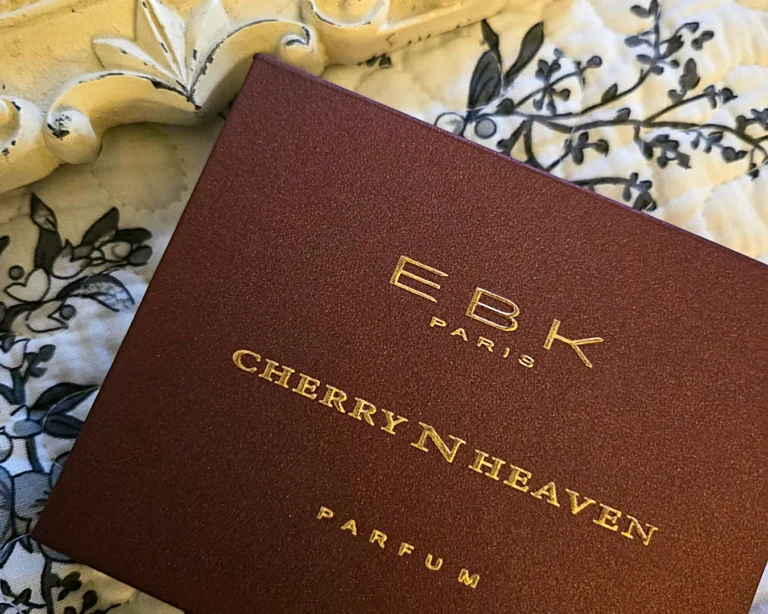 EBK Paris Cherries N Heaven parfum box photographed on patterned fabric with gold lettering